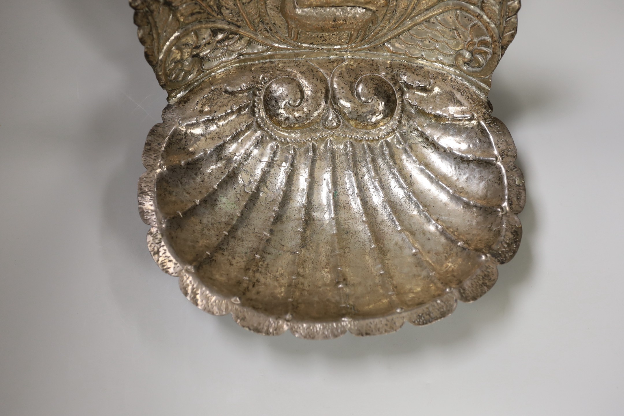 A South American white metal shell shaped baptismal font 29.5cm wide